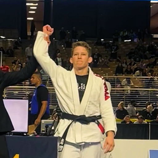 A picture of instructor Lakyn Bendle, 2nd degree black belt, winning a match.